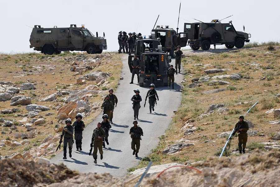 Israeli troops taking position during clashes between Palestinians and Israeli troops after Israeli machinery demolish a school near Bethlehem in the Israeli-occupied West Bank on Sunday –Reuters photo