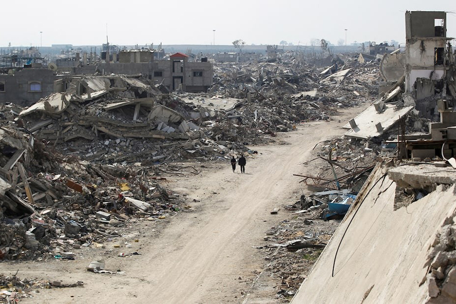 Palestinians walk past the rubble of buildings destroyed during the Israeli offensive, amid a ceasefire between Israel and Hamas, in Rafah in the southern Gaza Strip on February 4, 2025 — Reuters photo