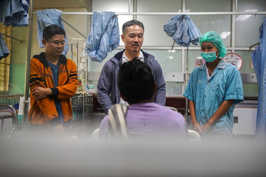 Tawatchai Yingtaweesak, a hospital director, speaks to Maung Lay, 45, a refugee from Myanmar who suffers from epilepsy and was transferred to Tha Song Yang Hospital following a halt in US foreign aid that led to the closure of health services inside Mae La refugee camp nearby on the Thai-Myanmar border, at Tha Song Yang district, Tak Province, a Thai-Myanmar border province, February 4, 2025.