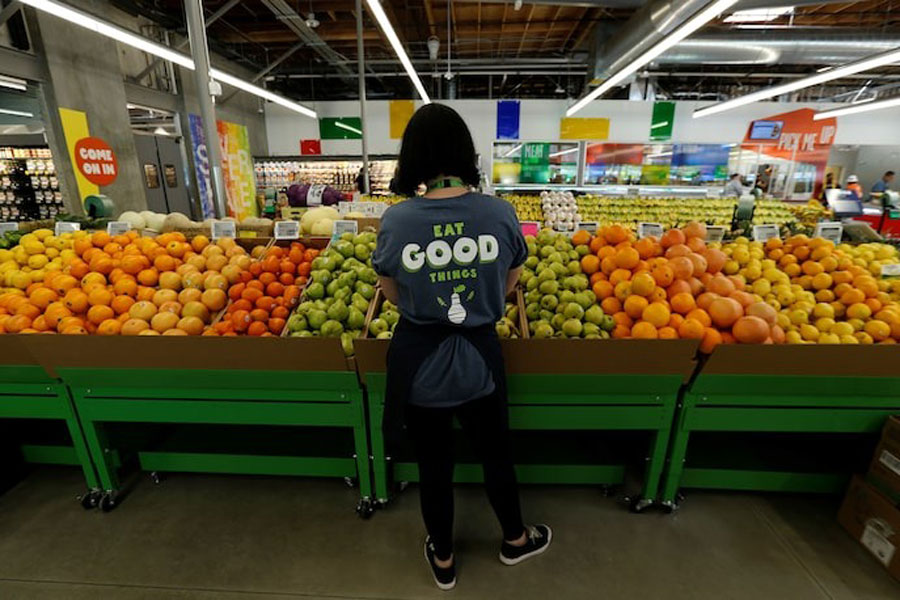 An employee checks pears at a 365 by Whole Foods Market grocery store ahead of its opening day in Los Angeles, US, May 24, 2016.