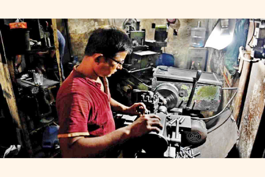 A worker at a light engineering factory in Dhaka.