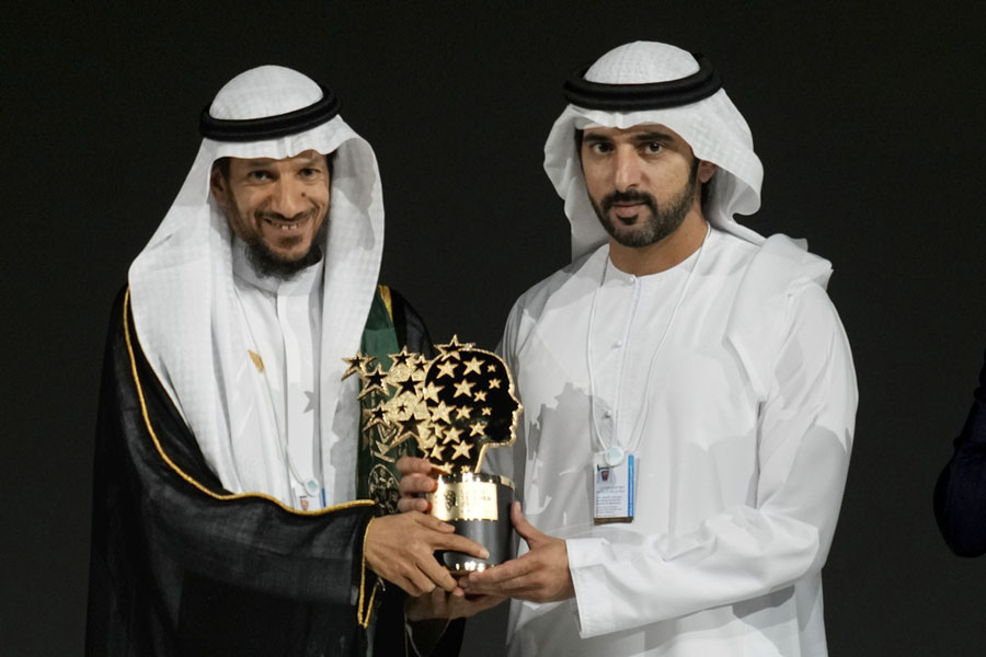 Saudi Arabian teacher Mansour bin Abdullah Al-Mansour, left, receives the Global Teacher Prize trophy from Dubai Crown Prince Sheikh Hamdan bin Mohammed Al Maktoum at a ceremony awarding the Global Teacher Prize in Dubai, United Arab Emirates, Thursday, Feb. 13, 2025.