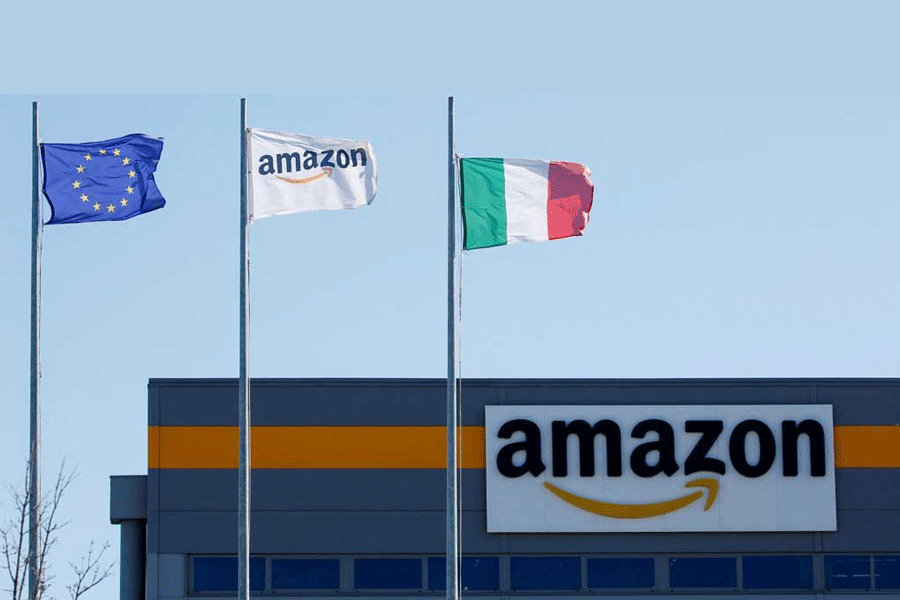 Flags flutter outside a distribution centre, during a strike at Amazon’s logistics operations in Italy, in Passo Corese, Italy Mar 22, 2021.