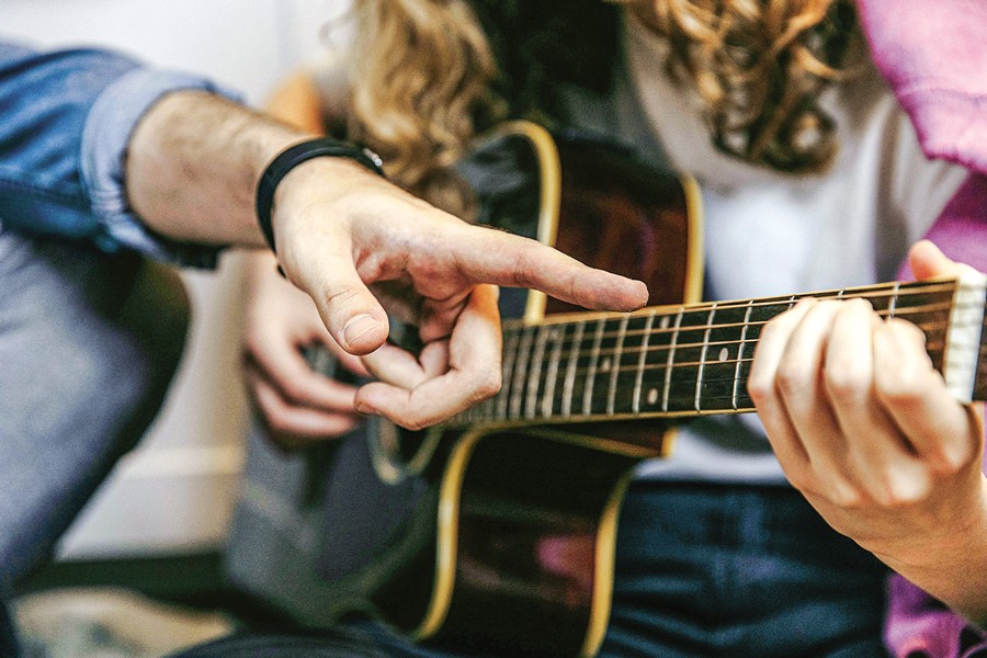 Playing acoustic guitar