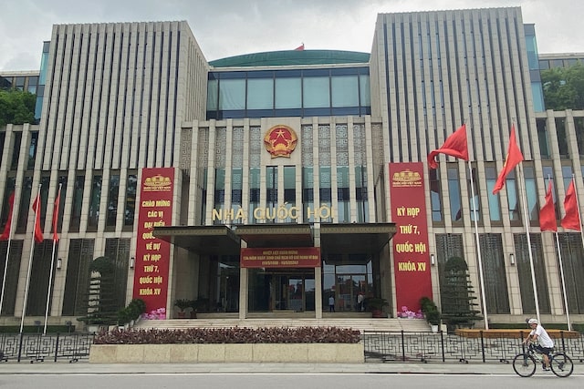 A man cycles in front of the National Assembly Building of Vietnam, in Hanoi, Vietnam, May 18, 2024. REUTERS/Francesco Guarascio/File Photo