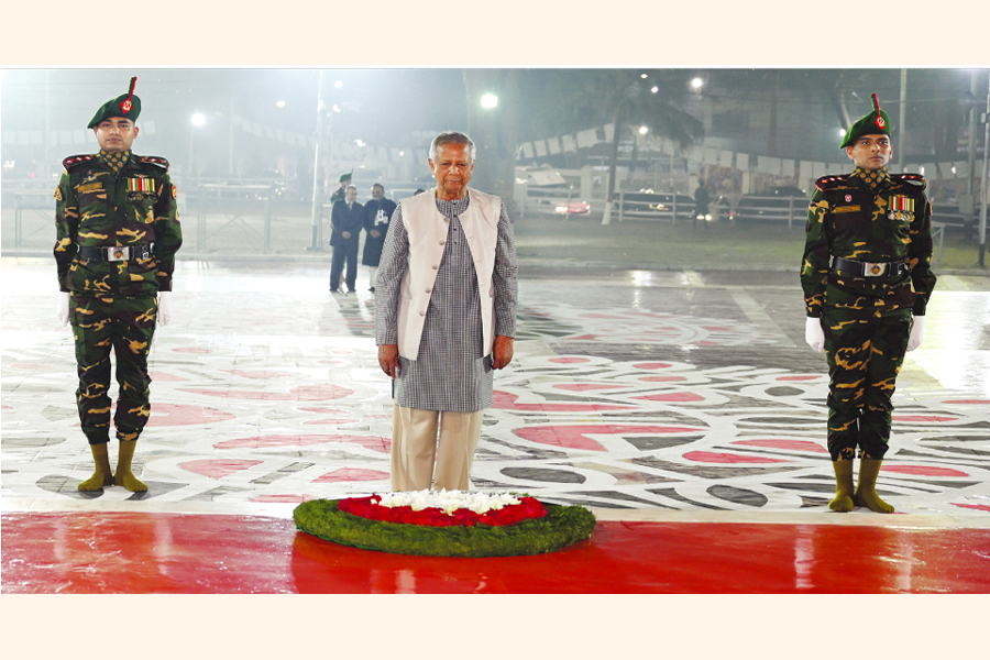 Chief Adviser Professor Muhammad Yunus stands in solemn silence while paying tributes to Language Movement martyrs at Central Shaheed Minar in the city in the first hour of Friday. —PID Photo
