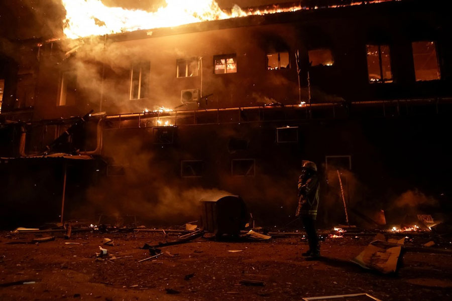 A firefighter works at a site of an apartment building damaged during a Russian drone strike, amid Russia's attack on Ukraine, in Kharkiv, Ukraine January 28, 2025.