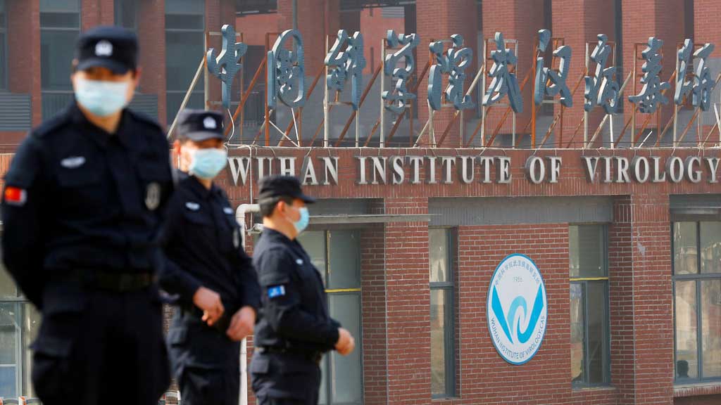 FILE PHOTO: Security personnel keep watch outside Wuhan Institute of Virology during the visit by the World Health Organization (WHO) team tasked with investigating the origins of the coronavirus disease (COVID-19), in Wuhan, Hubei province, China February 3, 2021. REUTERS