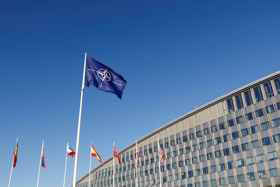 Flags fly outside NATO headquarters in Brussels, Belgium, November 16, 2022.
