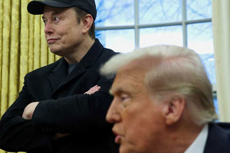 Elon Musk listens to US President Donald Trump speak in the Oval Office of the White House in Washington, DC, US, Feb 11, 2025.