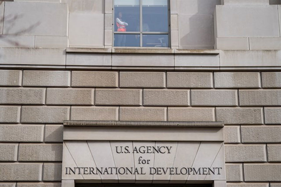A worker looks out of the window of the US Agency for International Development (USAID) building, after billionaire Elon Musk, who is heading US President Donald Trump's drive to shrink the federal government, said work is underway to shut down the US foreign aid agency USAID, in Washington, US, February 3, 2025.