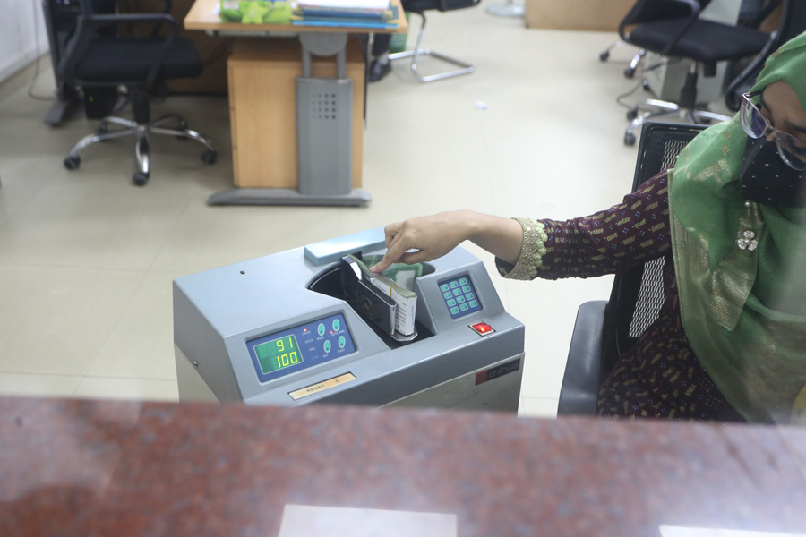 A bank staff is counting notes