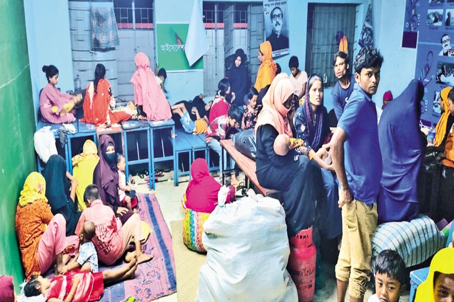 With cyclone Mocha approaching, people have taken refuge at a makeshift shelter at the Municipal Preparatory High School in Cox's Bazar on Saturday —Focus Bangla photo