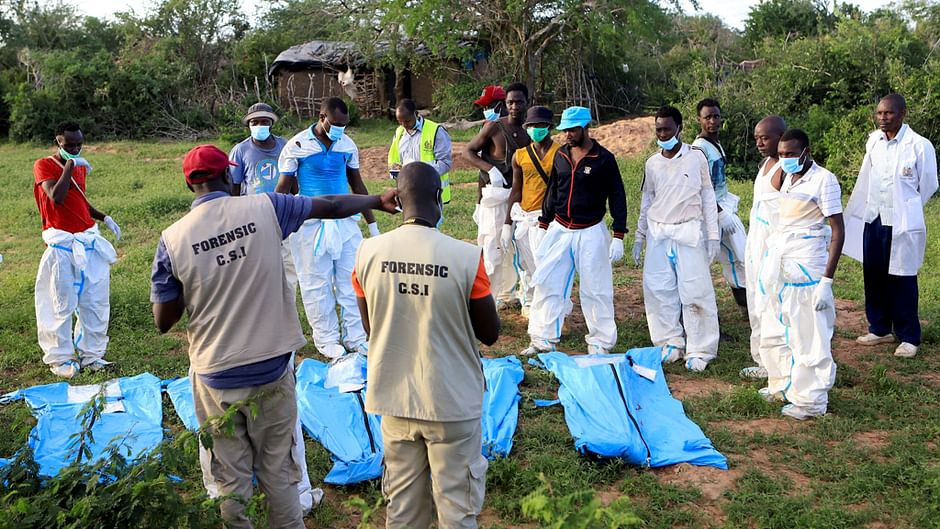 FILE PHOTO: Forensic experts and homicide detectives from the Directorate of Criminal Investigations (DCI), sort exhumed bodies of suspected followers of a Christian cult named Good News International Church, who believed that they would go to heaven if they starved themselves to death, in Shakahola forest of Kilifi county, Kenya May 11, 2023. REUTERS/Stringer