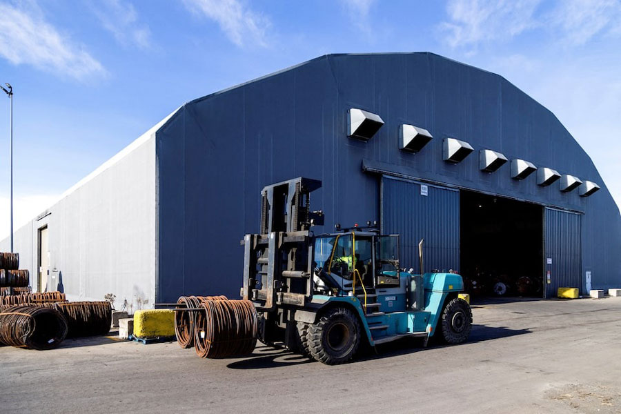 A worker operates a forklift to move coiled steel outside a warehouse at Ontario Shipyards in Hamilton, Ontario, Canada, January 27, 2025.