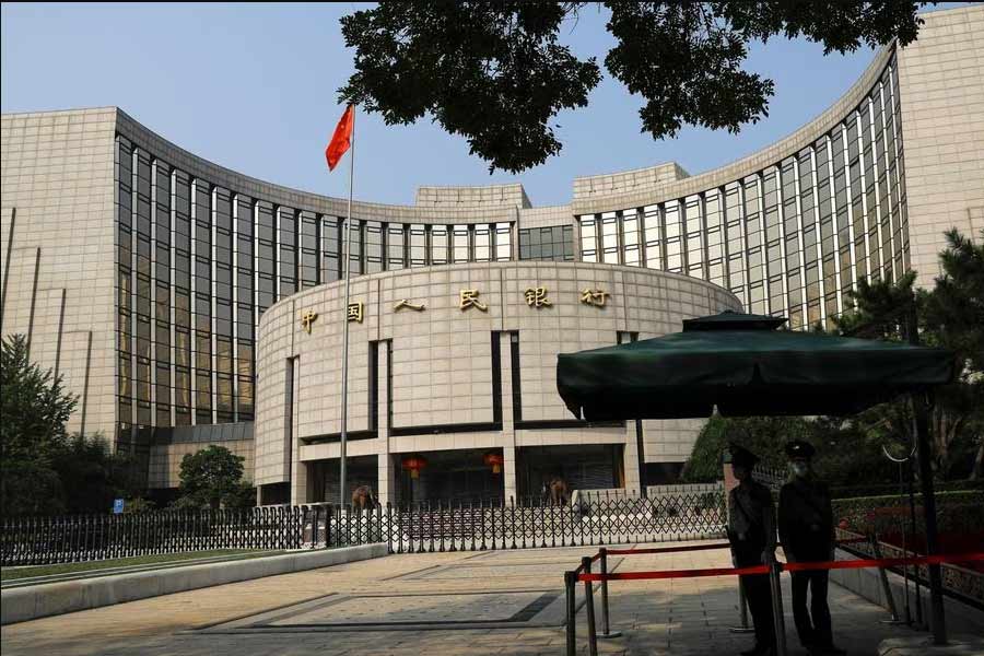 Paramilitary police officers standing guard in front of the headquarters of the People's Bank of China in Beijing on September 30 last year –Reuters file photo