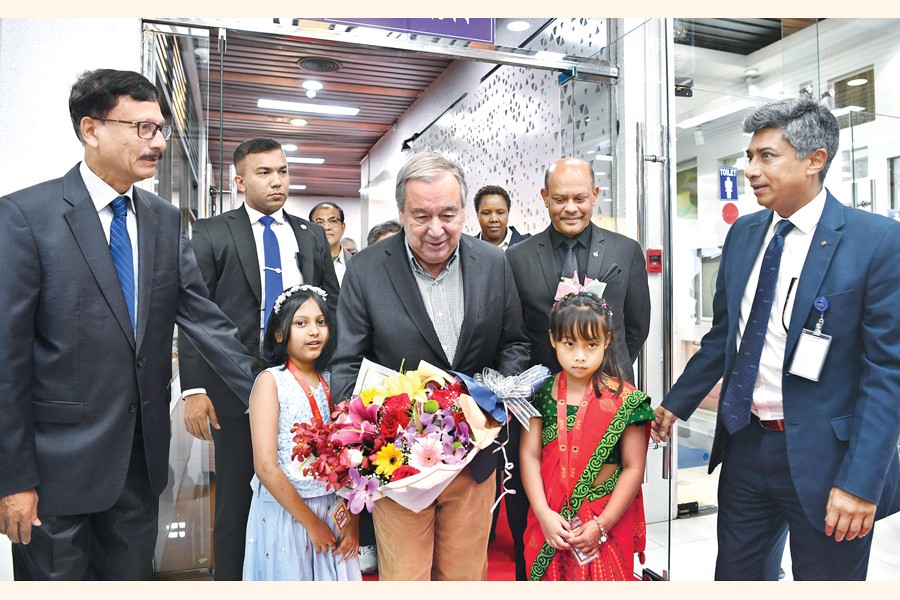 Two children present United Nations Secretary-General António Guterres with a bouquet at Hazrat Shahjalal International Airport in the capital on Thursday. Foreign Affairs Adviser Md Touhid Hossain welcomed the UN chief