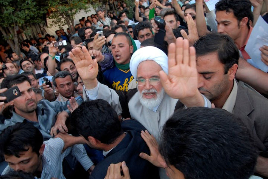 Iran's presidential candidate Mehdi Karroubi (3rd R) joins a crowd of supporters in Tehran June 17, 2009.
