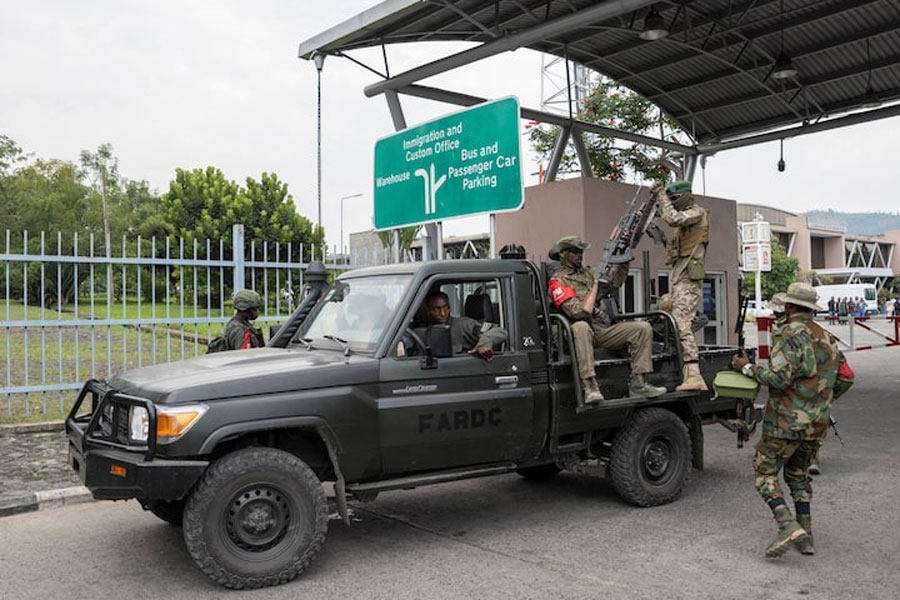 M23 rebels gather around a truck during the escort of captured FDLR members (not pictured) to Rwanda for repatriation, at the Goma-Gisenyi Grande Barrier border crossing, March 1, 2025.