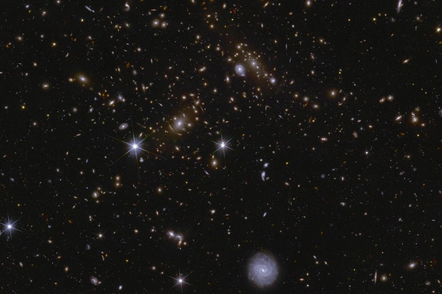 Image shows an area of a patch of sky called the Deep Field South observed by the Euclid space telescope, in this handout released by the European Space Agency on March 19, 2025. Various huge galaxy clusters are visible in this image, as well as intra-cluster light and gravitational lenses. The cluster near the center is called J041110.98-481939.3, and is located almost 6 billion light-years away.