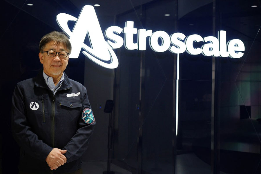 Eddie Kato, President & Managing Director of Astroscale Japan, poses in front of the company logo at its office in Tokyo, Japan, February 21, 2025.