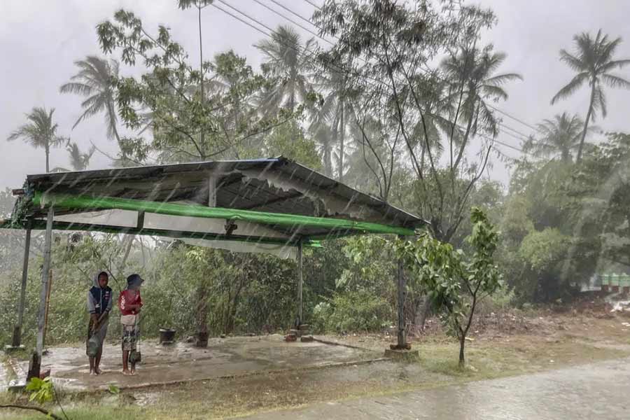 Two children standing under a roadside shelter to protect from rain before Cyclone Mocha hits in Rakhine State in Myanmar on May 14 this year –AP file photo