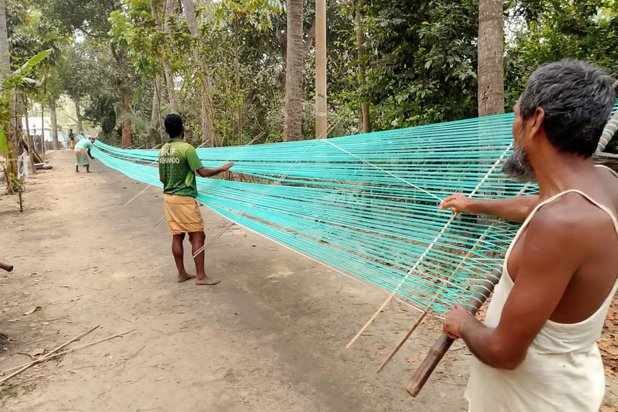 Weavers processing yarn before making lungis at a factory at Chachkiya village in Atgharia upazila of Pabna district, as Eid-ul-Fitr is approaching - FE Photo