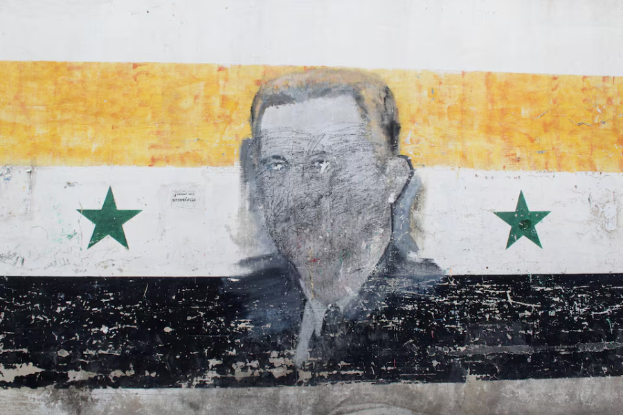 A wall painted with a damaged drawing of ousted Syrian President Bashar al-Assad is pictured in the al-Qadam neighbourhood in Damascus, Syria, March 26, 2025.