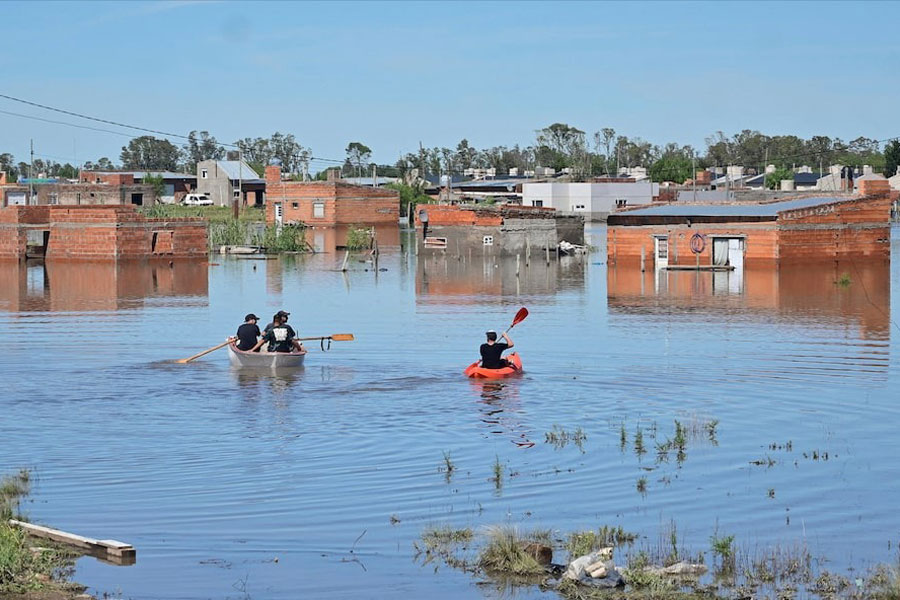 People row kayaks on flooded streets in the city of Bahia Blanca, in the province of Buenos Aires, Argentina March 9, 2025.