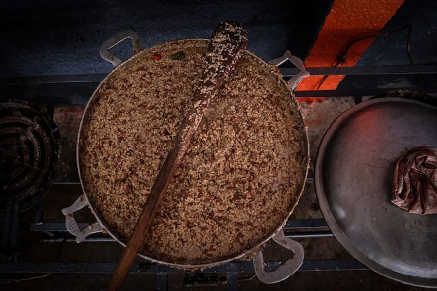 Food cooked by a community action center with the assistance of the United Nations World Food Programme, is prepared at Jeunes Filles high school, which was turned into a shelter for people displaced by gang war violence, in Port-au-Prince, Haiti, May 3, 2024.