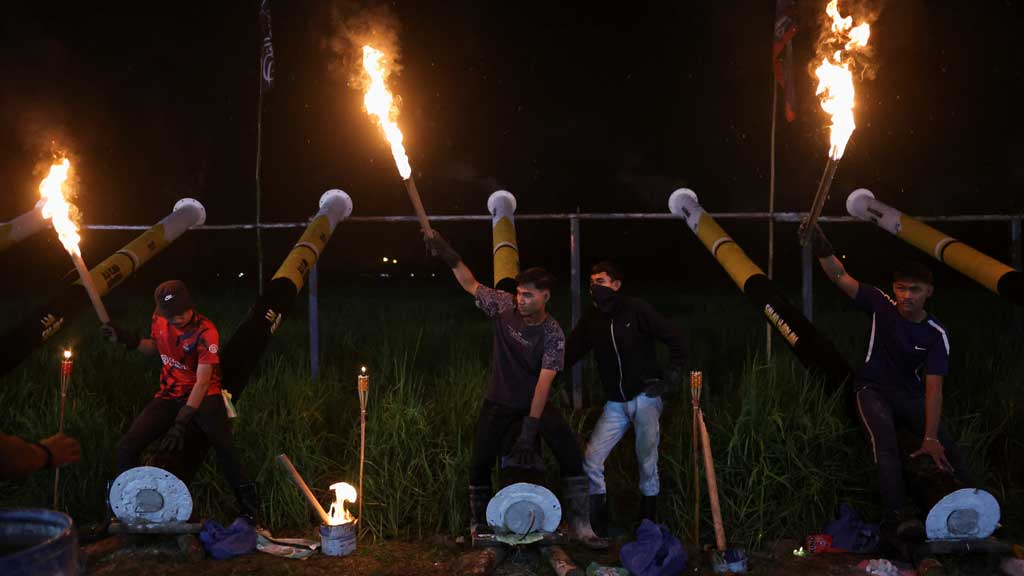 Villagers hold torches to light steel cannons as part of a tradition to welcome Eid-ul-Fitr on the eve of the celebration in Kuala Kangsar, Malaysia, on Mar 30, 2025.