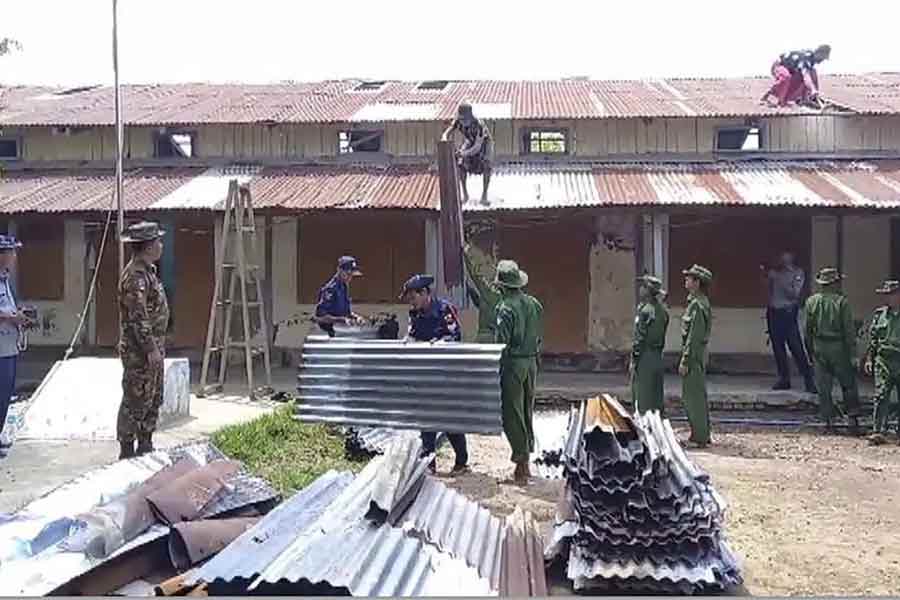Soldiers and members of fire service helping to repair a damaged buildings damaged by recent Cyclone Mocha in Pyapon township in Myanmar -AP photo