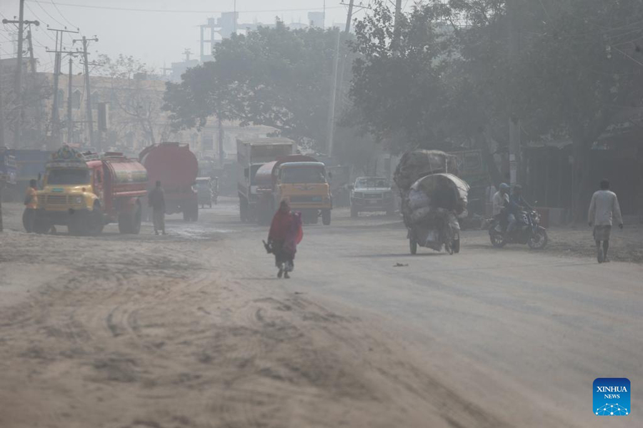 Vehicles move on a road amid thick smog in Dhaka on December 11, 2024. The capital city's air quality has worsened beyond recuperation