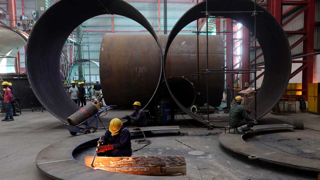 A worker cuts a metal plate inside an industrial tank manufacturing factory on the outskirts of Ahmedabad, India, January 31, 2025. REUTERS