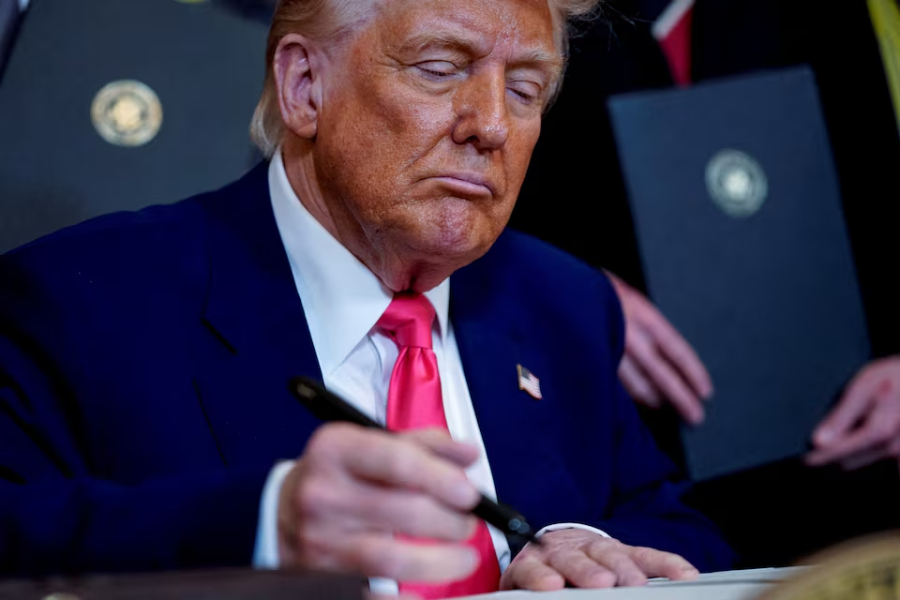 U.S. President Donald Trump signs an executive order at the White House in Washington, D.C., U.S., April 8, 2025.