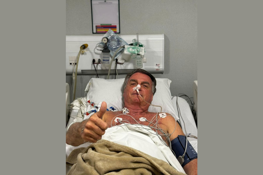 Former Brazilian President Jair Bolsonaro gestures as he lies in a bed in Rio Grande Hospital, in Natal, Brazil, in this social media picture obtained by Reuters on April 12, 2025.