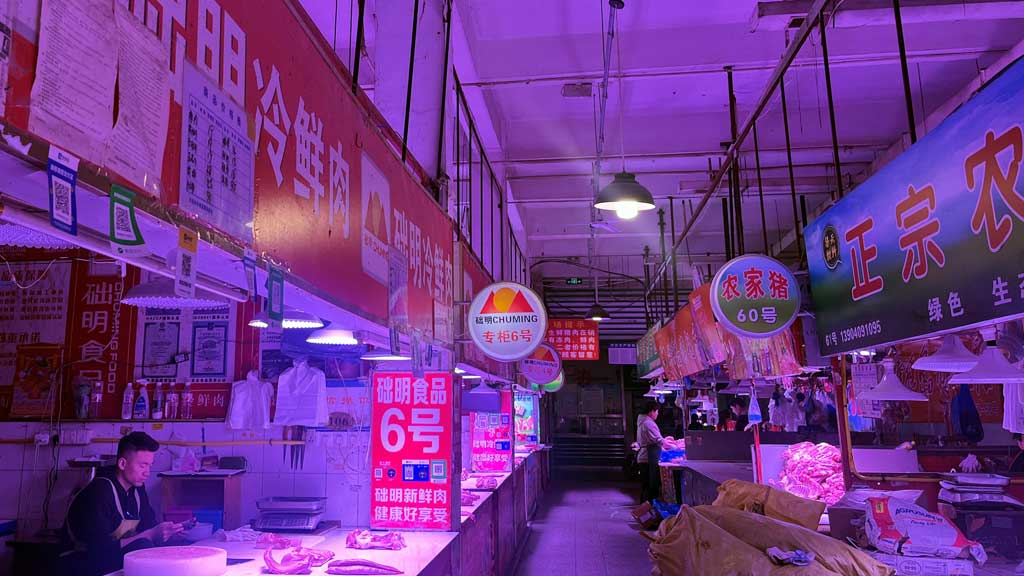 Signs showing Chuming Meat branding are displayed at a market in Dalian, Liaoning province, China March 26, 2025. REUTERS