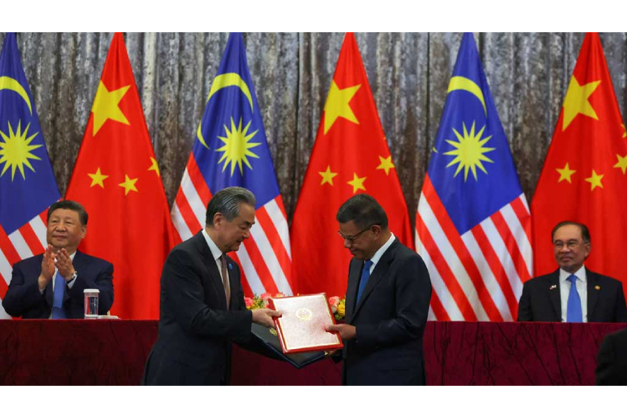 Skateboarder Juanjo Urbizu, 88, poses for a picture next to his car in Bilbao, Spain, March 15, 2024.