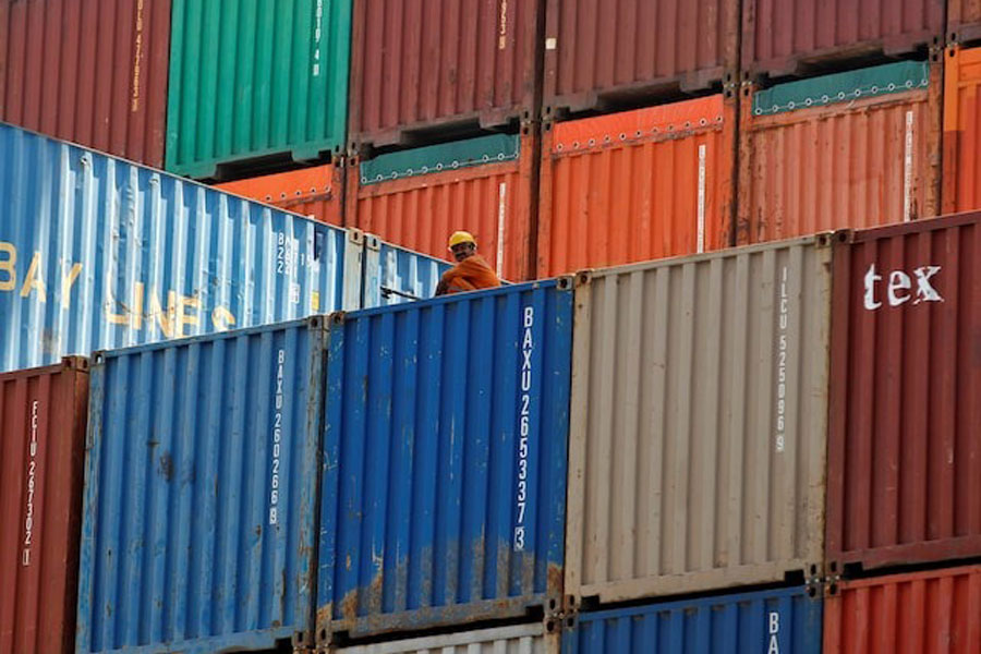 A worker sits on a ship carrying containers at Mundra Port in the western Indian state of Gujarat April 1, 2014.
