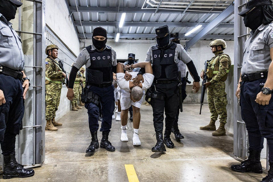Salvadoran prison guards escort alleged members of the Venezuelan gang Tren de Aragua and the MS-13 gang recently deported by the US government to be imprisoned in the Terrorism Confinement Center prison, in Tecoluca, El Salvador April 12, 2025 — Secretaria de Prensa de la Presidencia/Handout via REUTERS