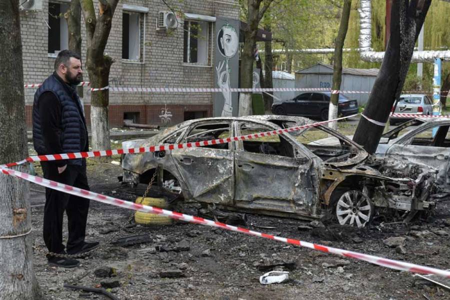 A resident stands next to burned cars at the site of a Russian drone strike, amid Russia’s attack on Ukraine, in Dnipro, Ukraine Apr 17, 2025.
