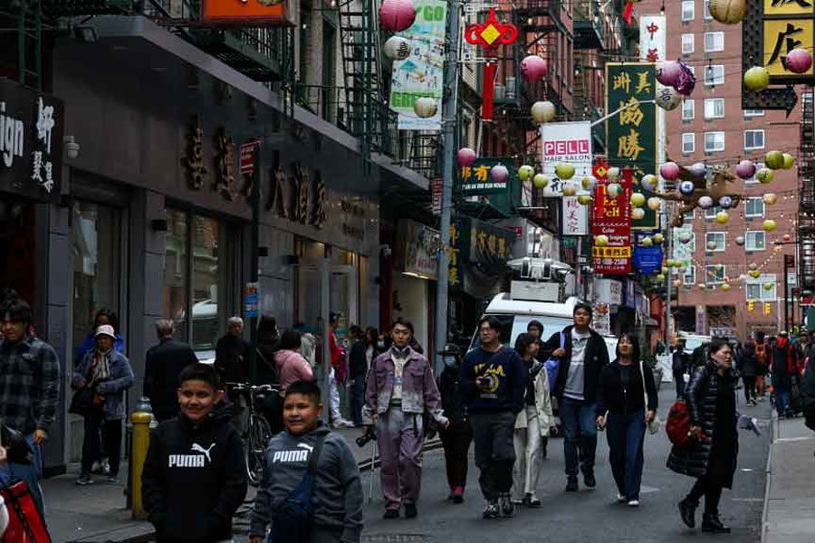 Sun Vin Grocery Manager Jasmine Bai points at the packaging and price of dried bean curd imported from China at the store in Chinatown in New York City, US, Apr 16, 2025.