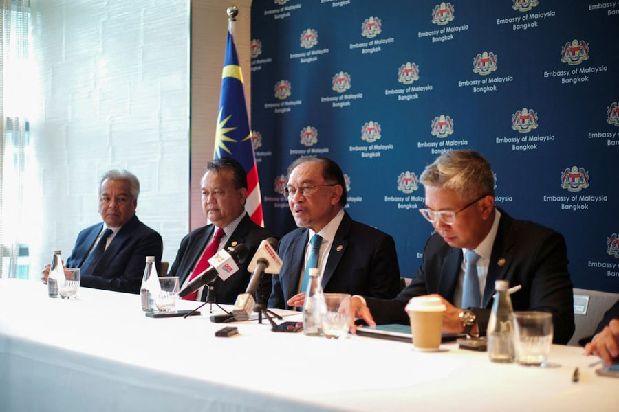Malaysian Prime Minister Anwar Ibrahim speaks during a press conference, next to Malaysia's Trade Minister Tengku Zafrul Aziz, Secretary General of the Ministry of Foreign Affairs Amran Mohamed Zin and Works Minister Datuk Seri Alexander Nanta Linggi, following talks with a key Myanmar opposition group, a day after meeting with Myanmar's junta chief Min Aung Hlaing in Bangkok, Thailand, April 18, 2025.