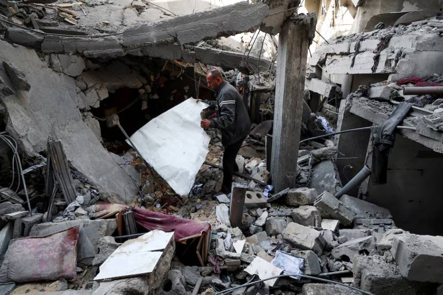 A Palestinian man inspects the damage at the site of an Israeli strike on a house, in the northern Gaza Strip, April 18, 2025.