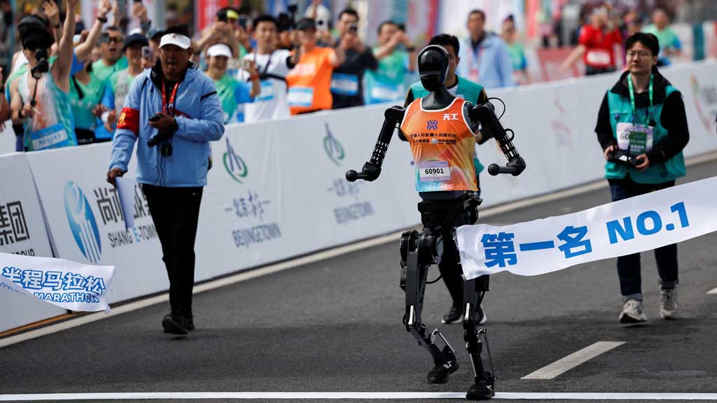 Tiangong Ultra, a humanoid robot runs across the finish line while securing the first position during the E-Town Humanoid Robot Half Marathon, in Beijing, China April, 19 2025. REUTERS