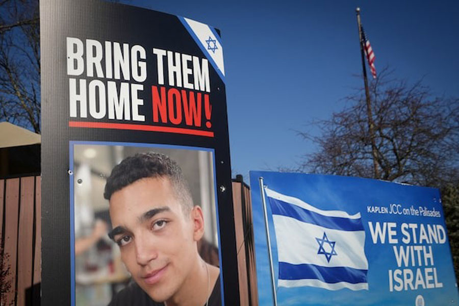 Signs and a photograph of Edan Alexander, the American-Israeli and Israel Defense Forces soldier taken hostage during the October 7, 2023 attack on Israel by Hamas, stand outside a Jewish community center in Alexander’s home town of Tenafly, New Jersey, US, December 14, 2024.