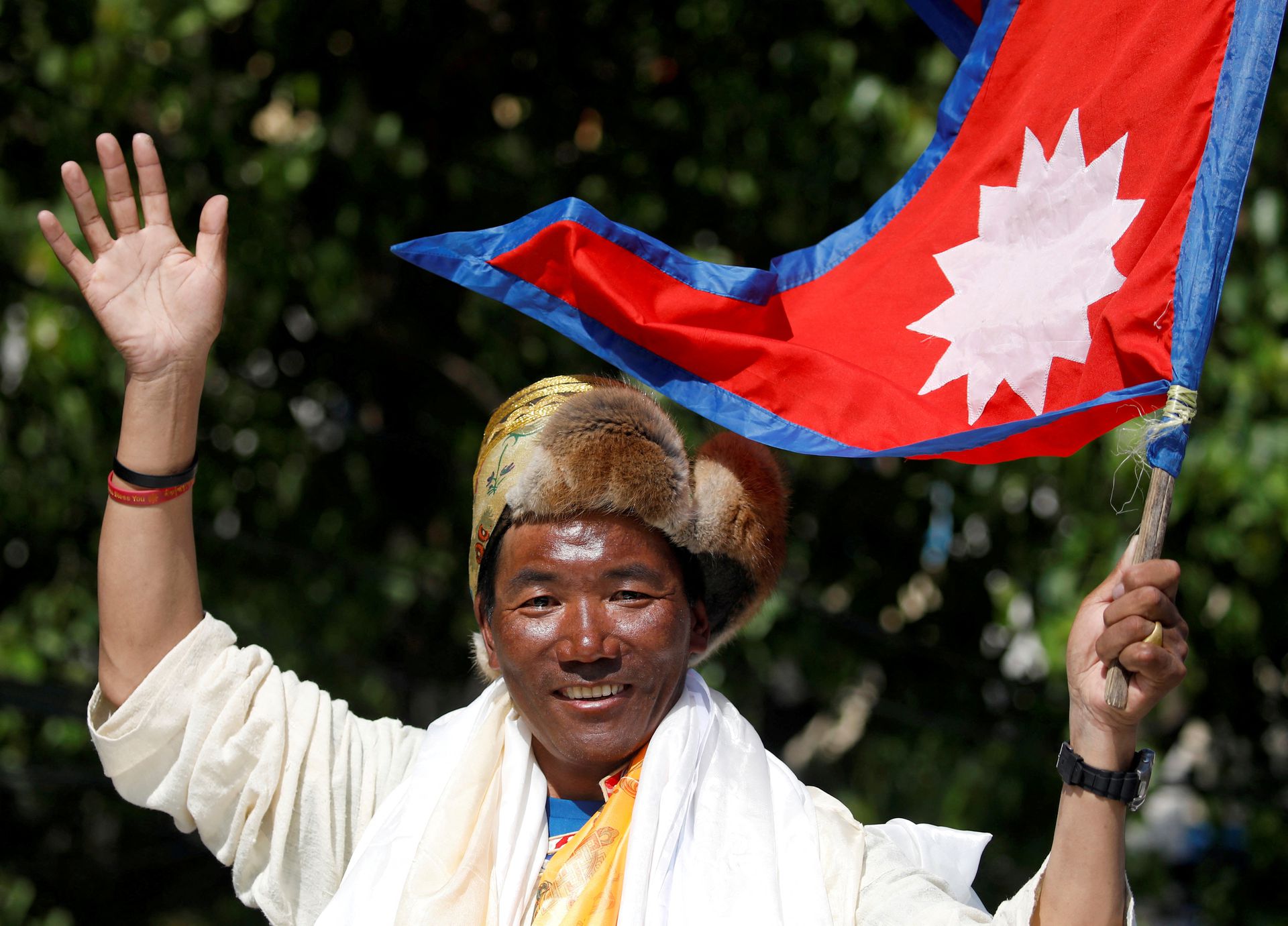 Nepali mountaineer Kami Rita Sherpa waves upon his arrival after climbing Mount Everest for the 24th time in 2019, setting a record for the most summits of the world's highest mountain, in Kathmandu, Nepal May 25, 2019. REUTERS/Navesh Chitrakar/File Photo