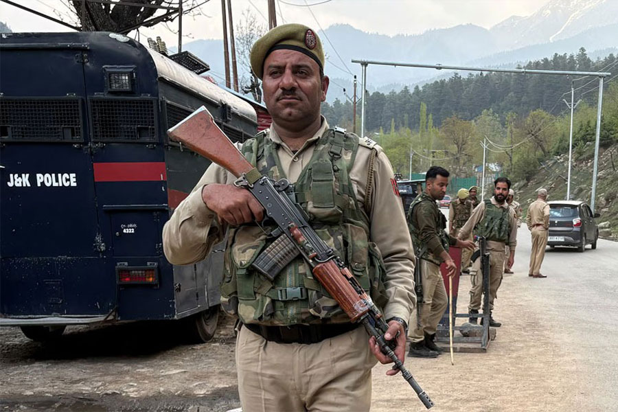 Indian police officers stand guard at a check point following a suspected militant attack, near Pahalgam in south Kashmir's Anantnag district, April 22, 2025.