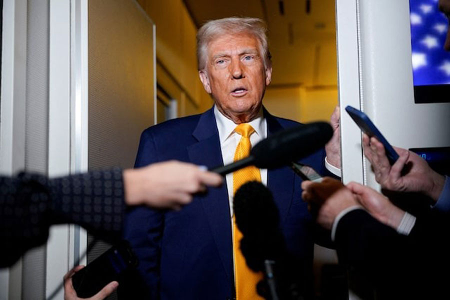 US President Donald Trump speaks to the media on board Air Force One on the way to Miami, Florida, US, April 12, 2025.