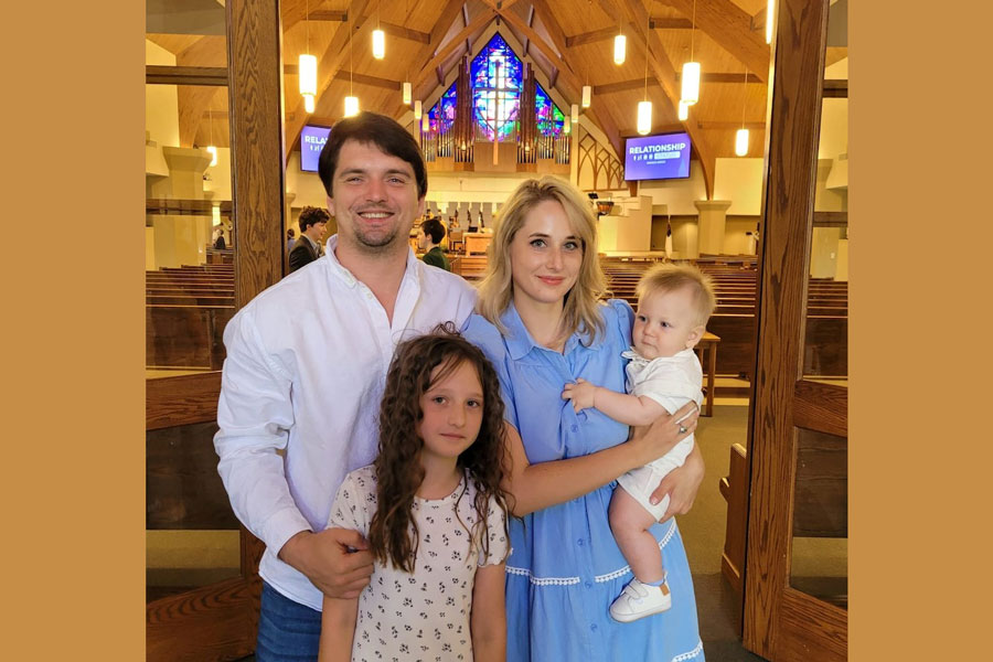 Taras Atamanchuk with his daughter Violet and wife Viktoria attend his son Maximilian's baptism at a church in Sugar Land, Texas, US, April 14, 2024.